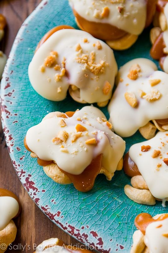 white chocolate caramel cashew clusters on a blue plate