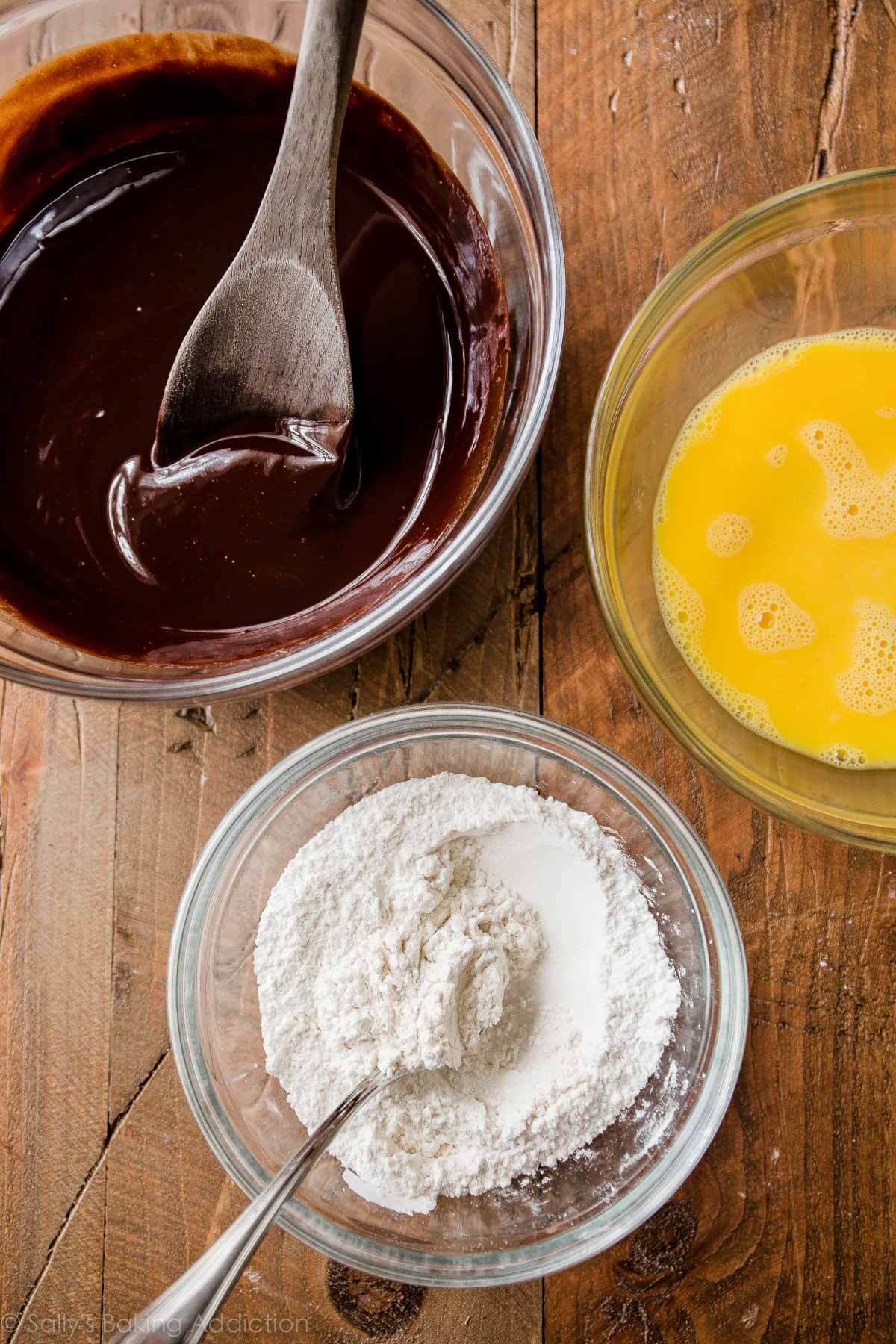 melted chocolate, whisked eggs, and flour mixture in glass bowls