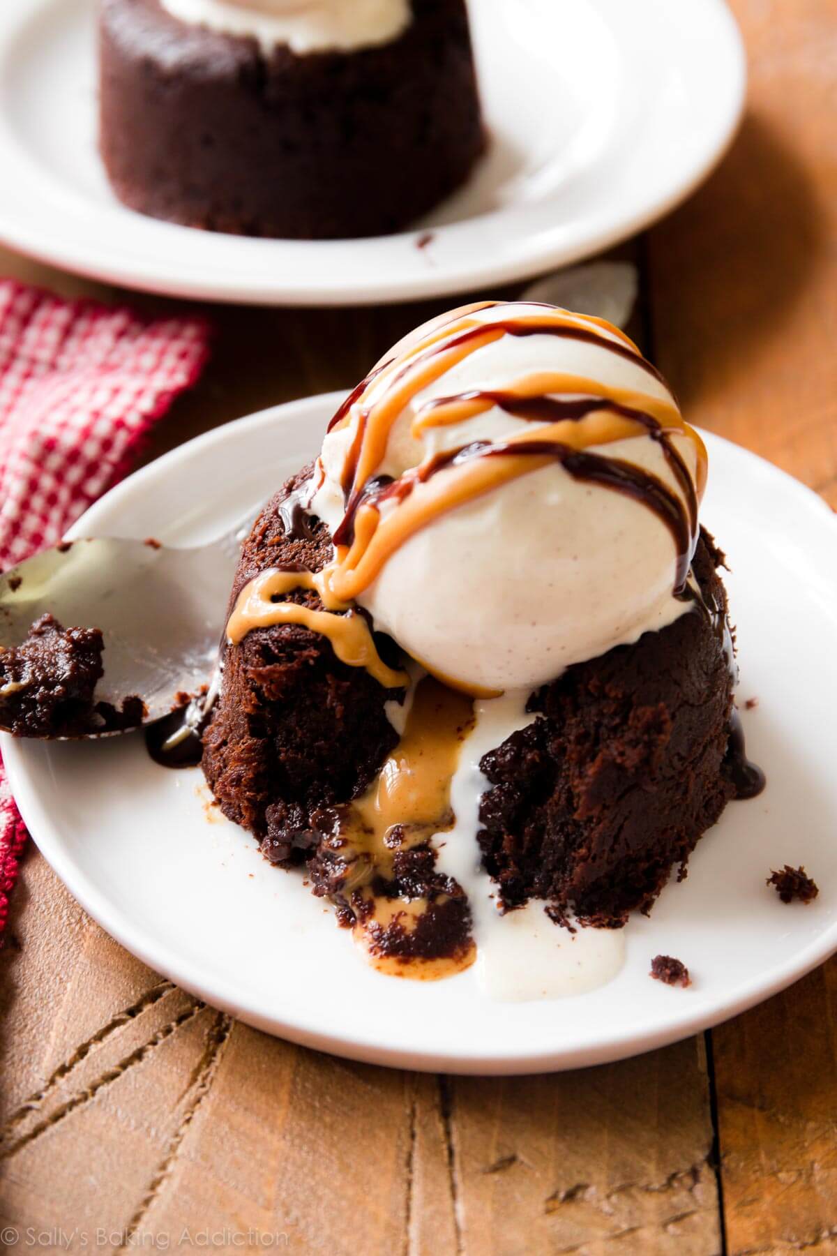 peanut butter chocolate lava cake on a white plate with a scoop of vanilla ice cream on top