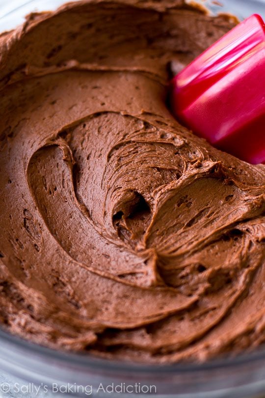 milk chocolate frosting in a glass bowl with a spatula