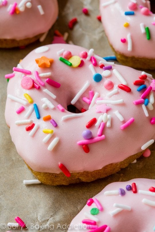 heart shaped donuts topped with pink glaze and sprinkles