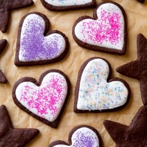 heart and star chocolate sugar cookies decorated with royal icing and sprinkles