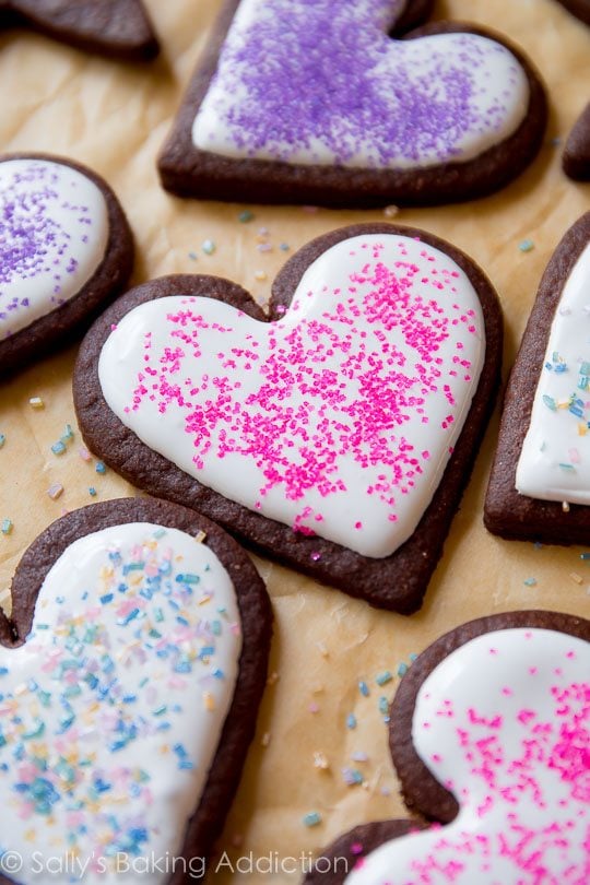 heart chocolate sugar cookies decorated with royal icing and sprinkles