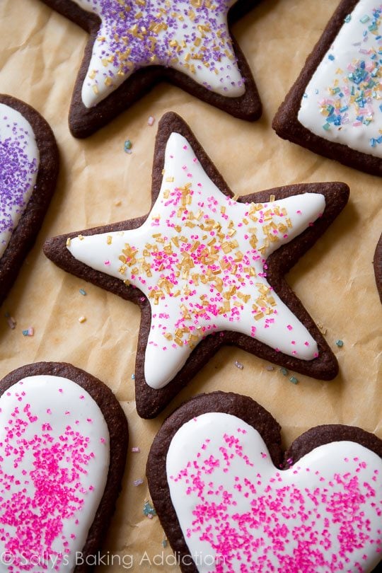 star chocolate sugar cookies decorated with royal icing and sprinkles