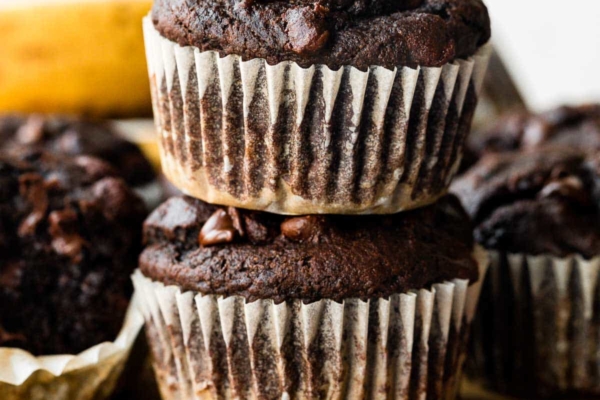 up close stack of 2 chocolate banana muffins.