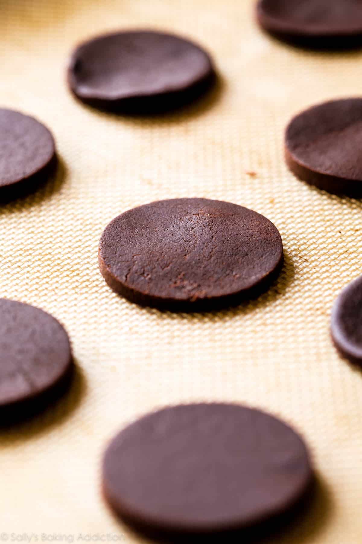 circle chocolate sugar cookies on a silpat baking mat before baking