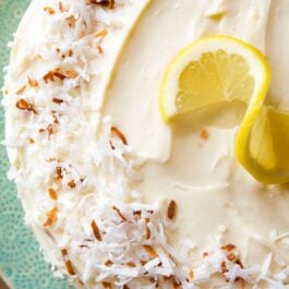 overhead image of lemon coconut cake on a teal plate