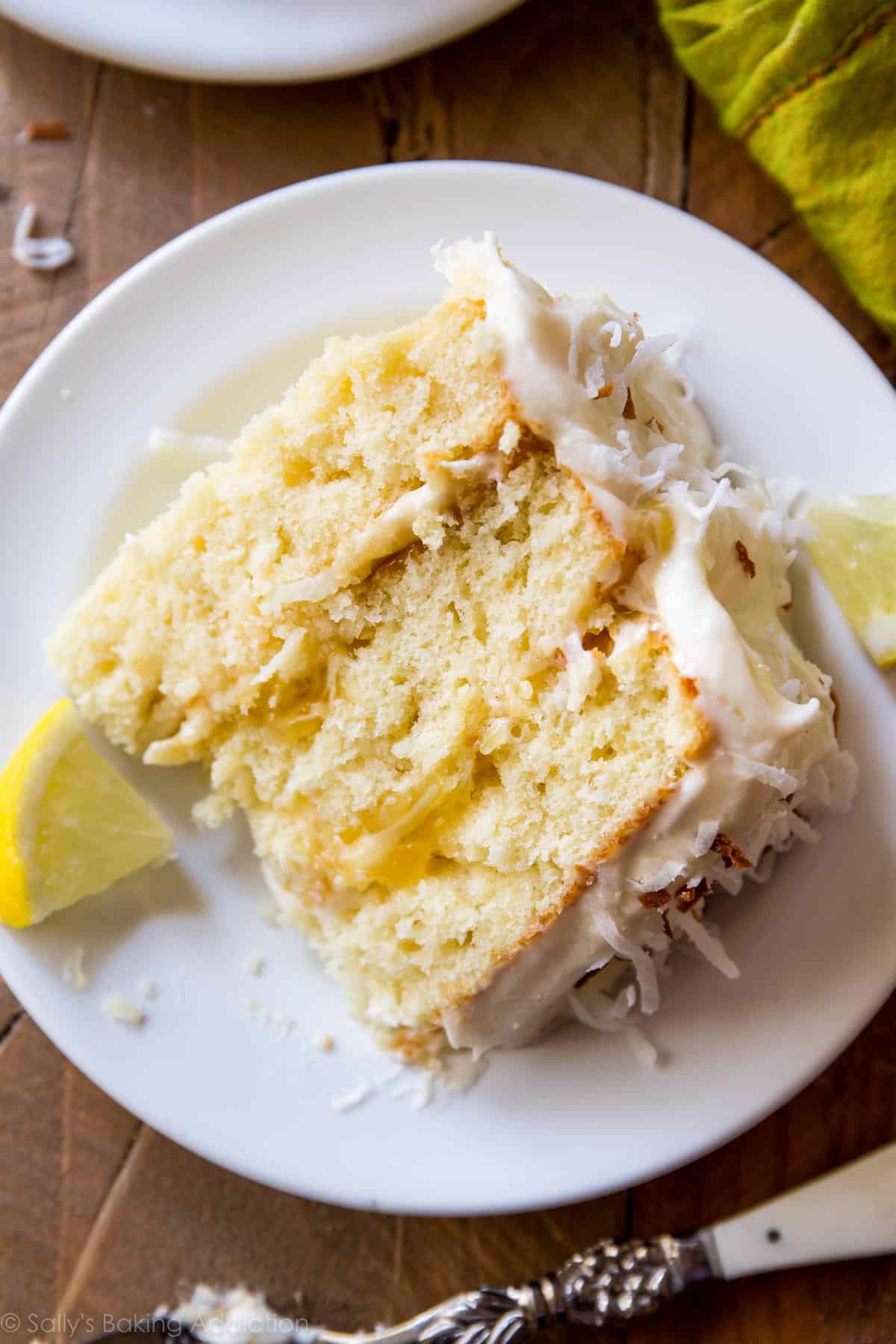 slice of lemon coconut cake on a white plate