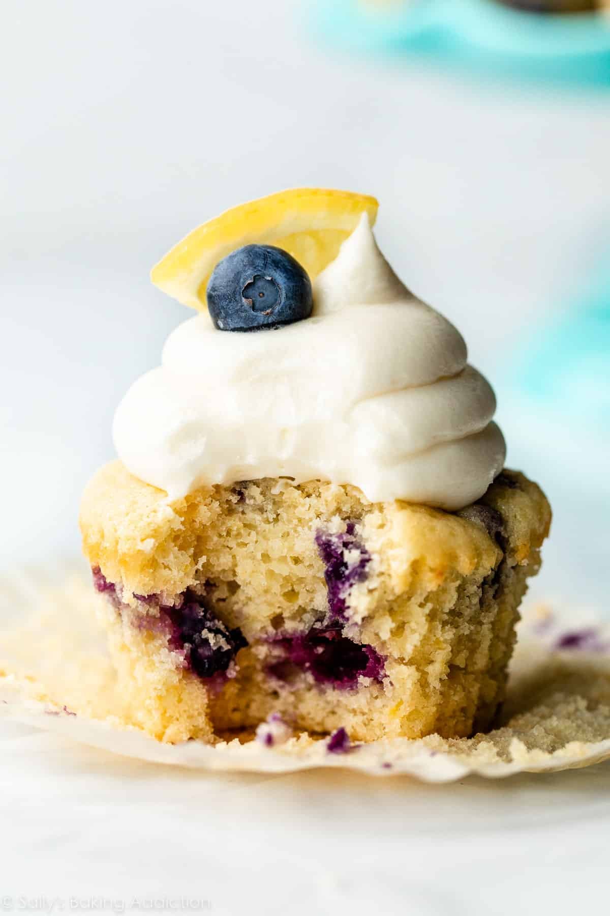 lemon blueberry cupcake with bite taken out of it.
