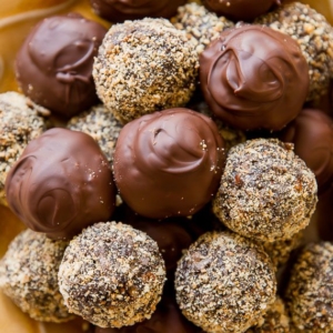 dark chocolate coconut rum balls on a gold plate