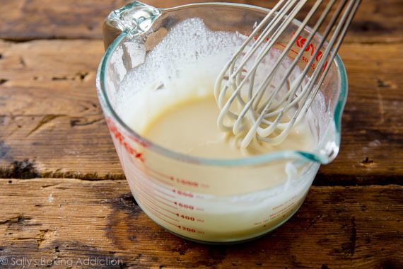 glaze in a glass measuring cup with a whisk
