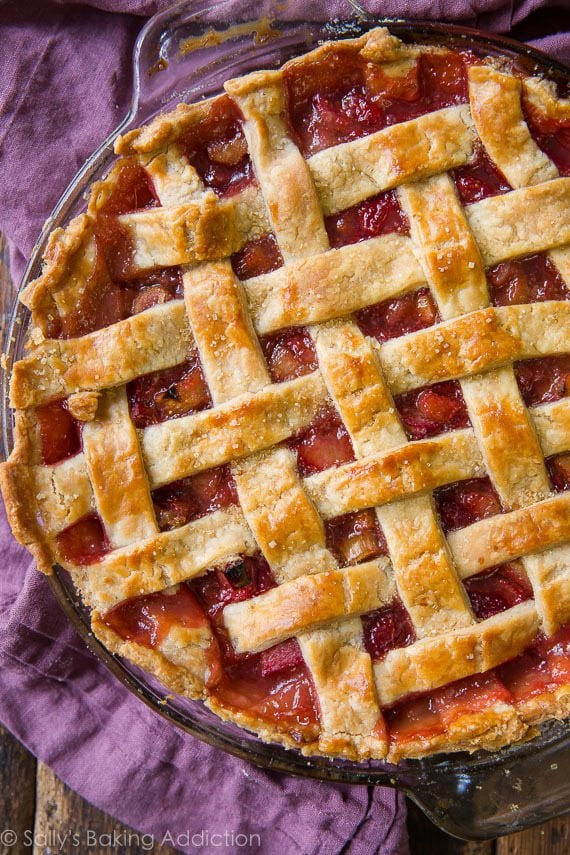 overhead image of strawberry rhubarb pie in a glass pie dish