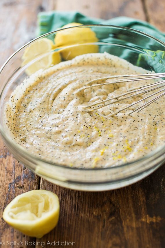 lemon poppy seed pancake batter in a glass bowl with a whisk