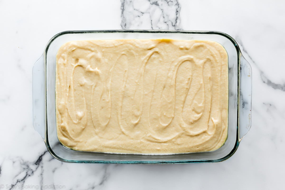 yellow cake batter in a glass cake pan
