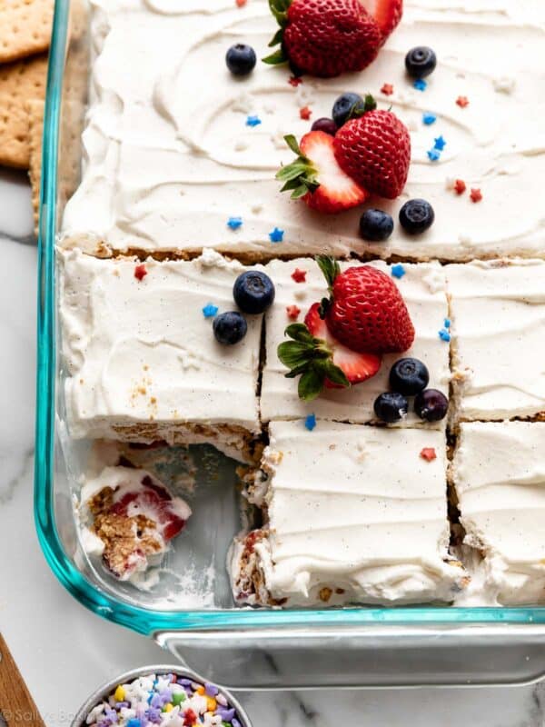 berry icebox cake in glass plan with slices cut out.