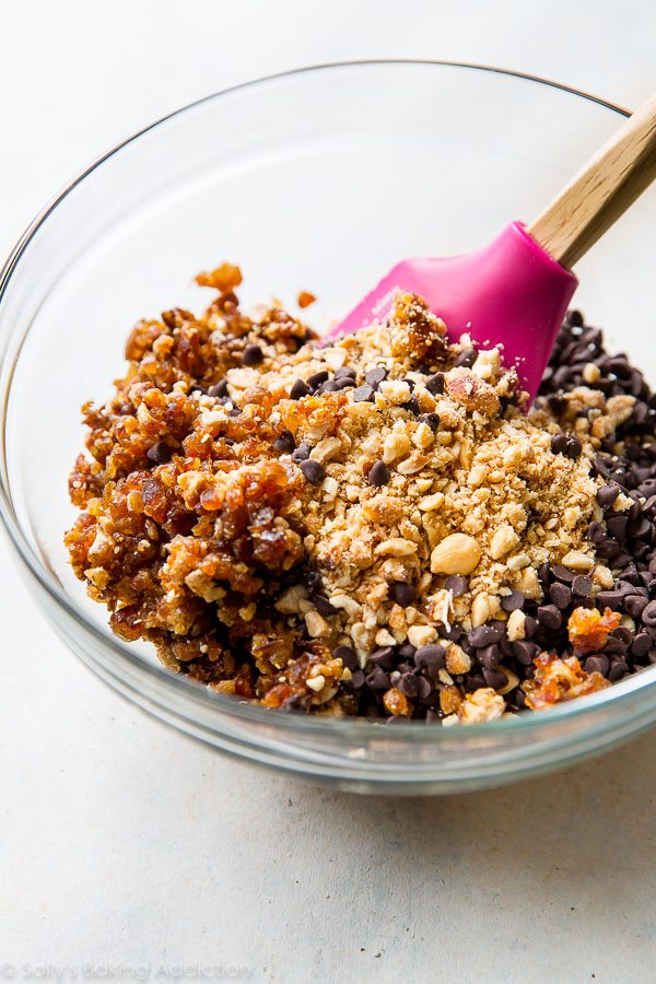 ingredients for chocolate peanut butter snack bars in a glass bowl with a spatula