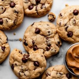 peanut butter chocolate chip cookies on marble backdrop.