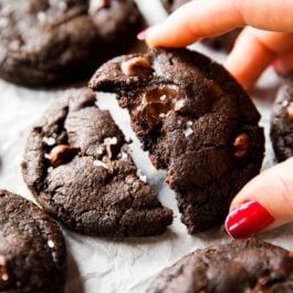 hand holding half of a salted dark chocolate cookie