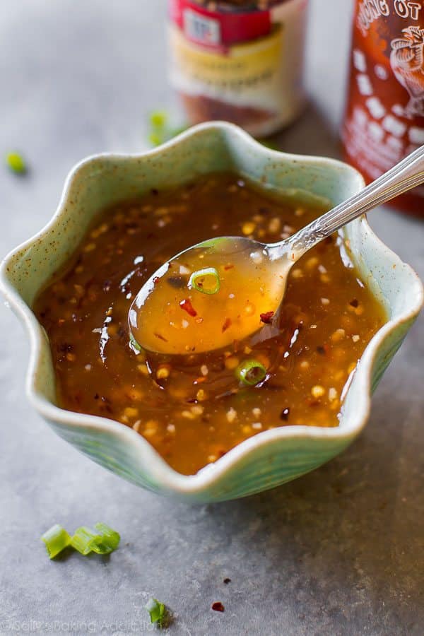 sweet chili sauce in a green bowl with a spoon