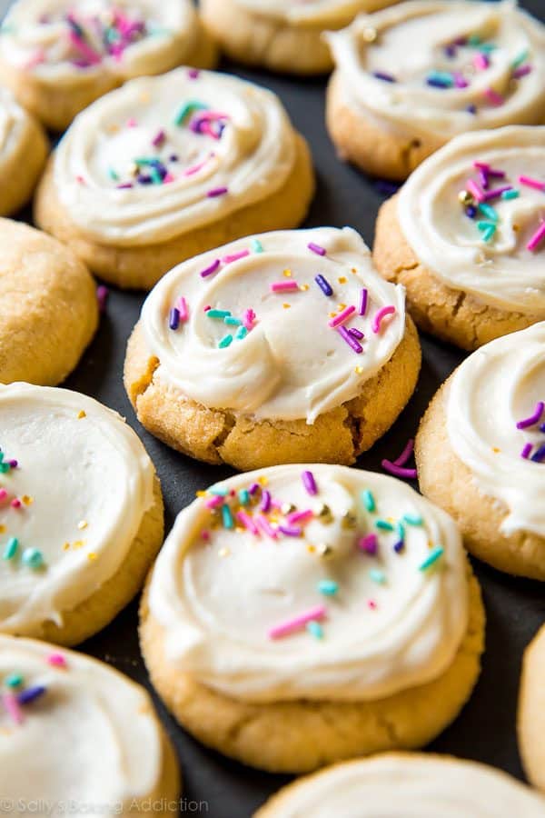 cream cheese sugar cookies topped with cream cheese frosting and sprinkles