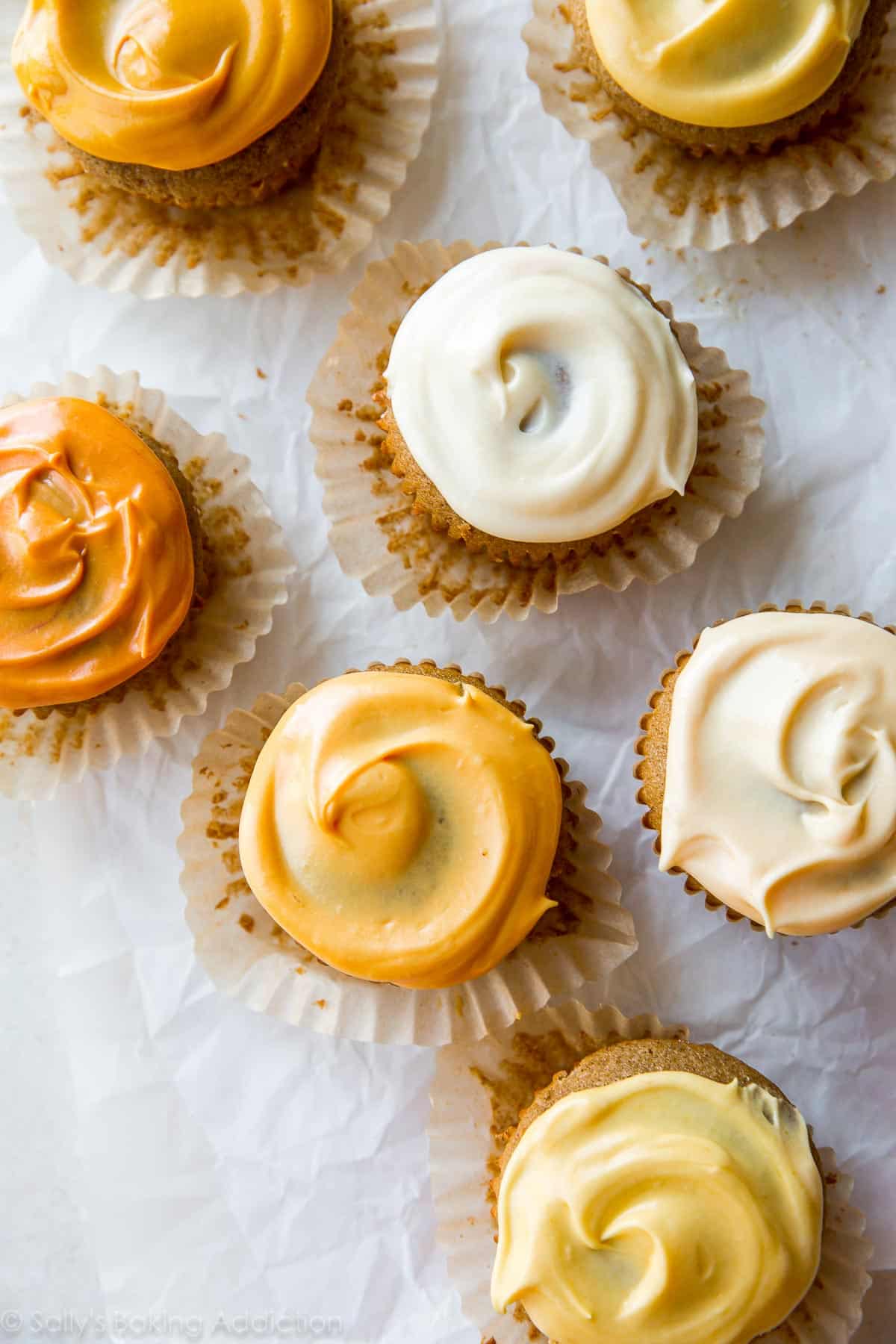 overhead image of cupcakes with orange ombre frosting