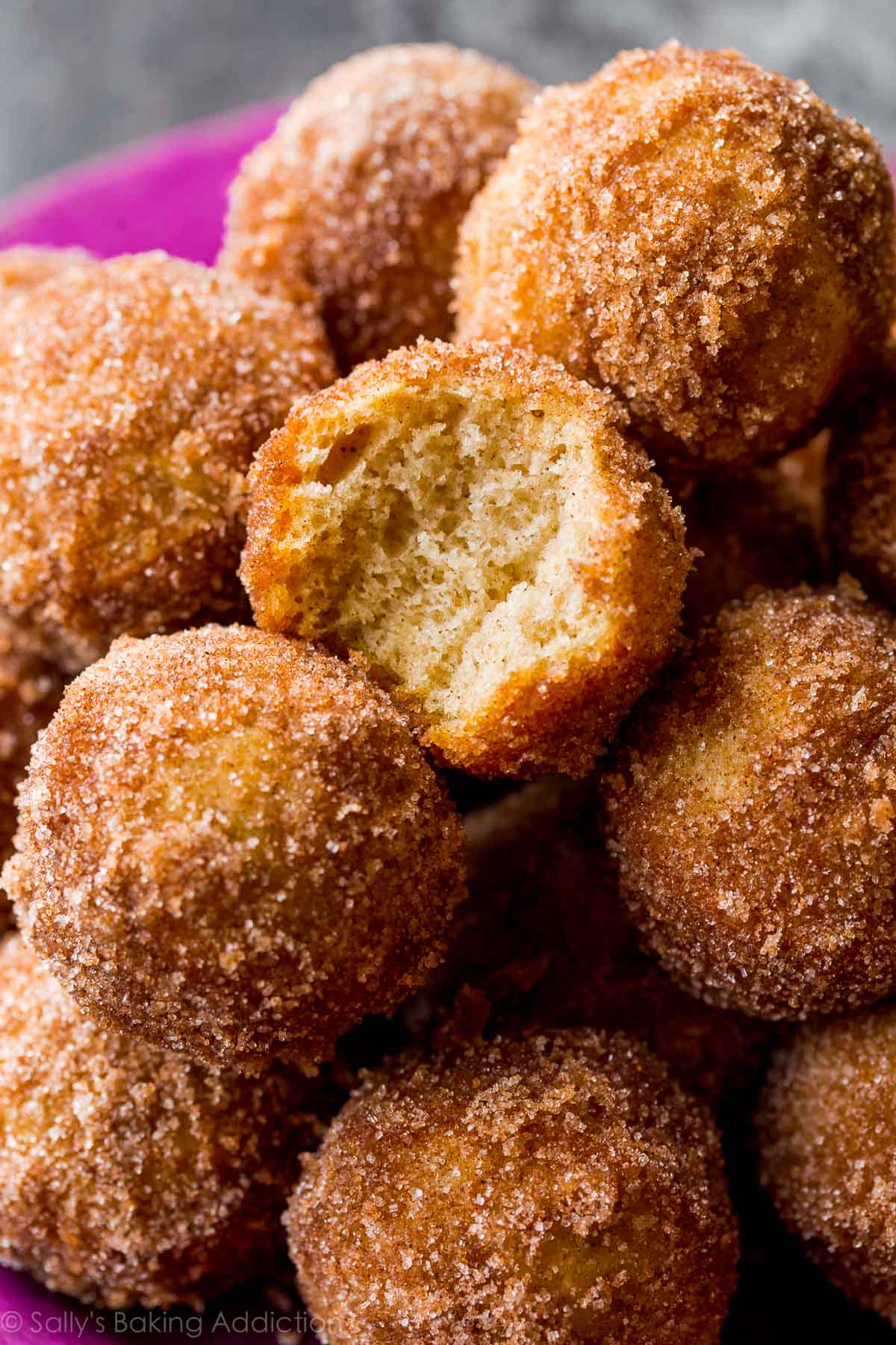 chai spice donut holes with a bite out of one showing the inside