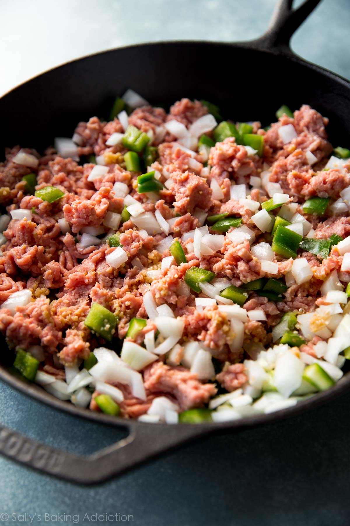 ground turkey, peppers, and onions sautéing in a skillet