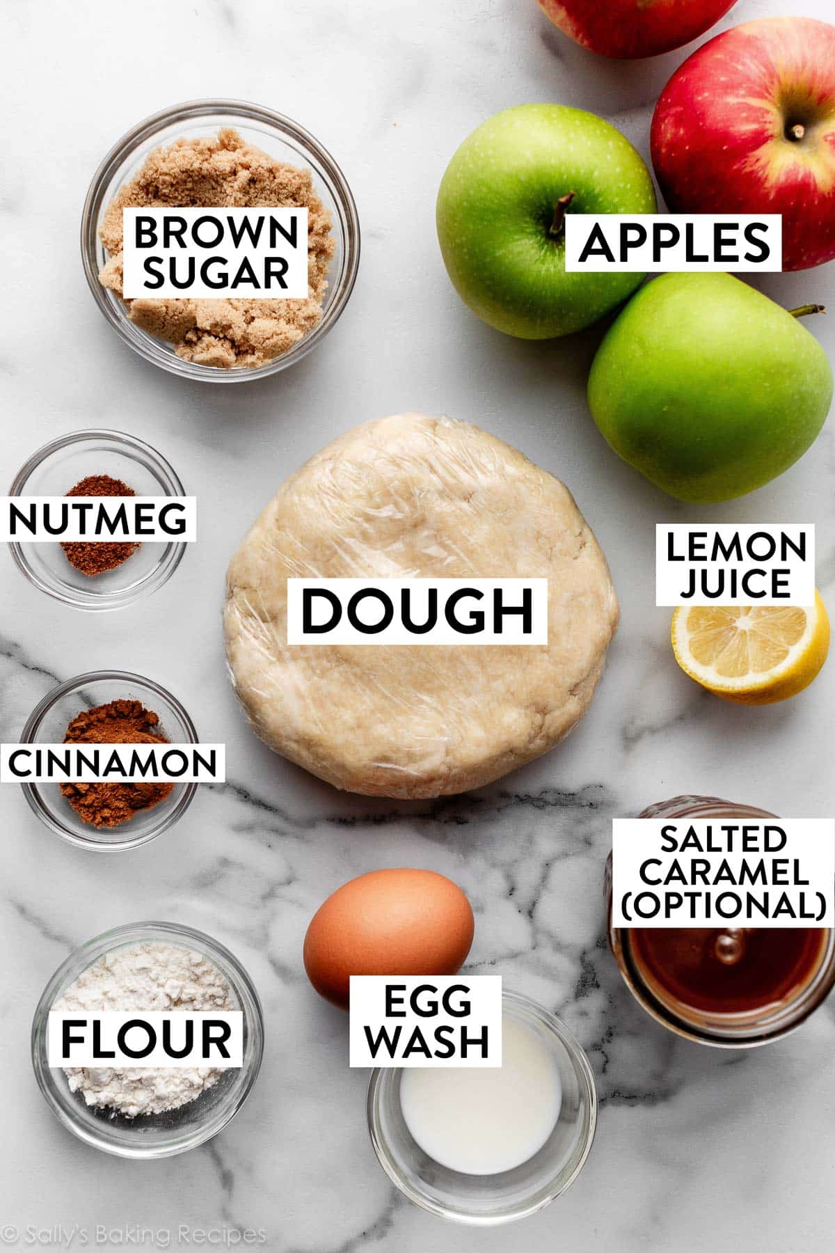 ingredients on counter including disc of dough, jar of salted caramel, lemon, brown sugar, egg, flour, and cinnamon.