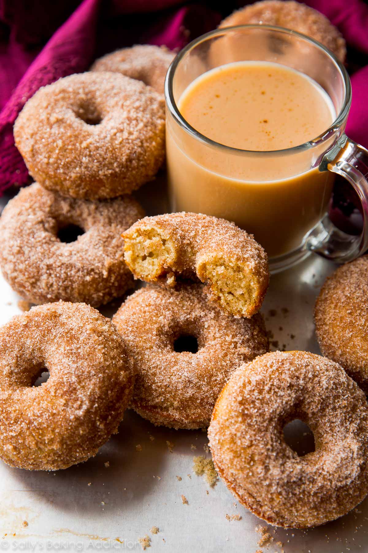 chai spice donuts with a cup of coffee in a glass mug