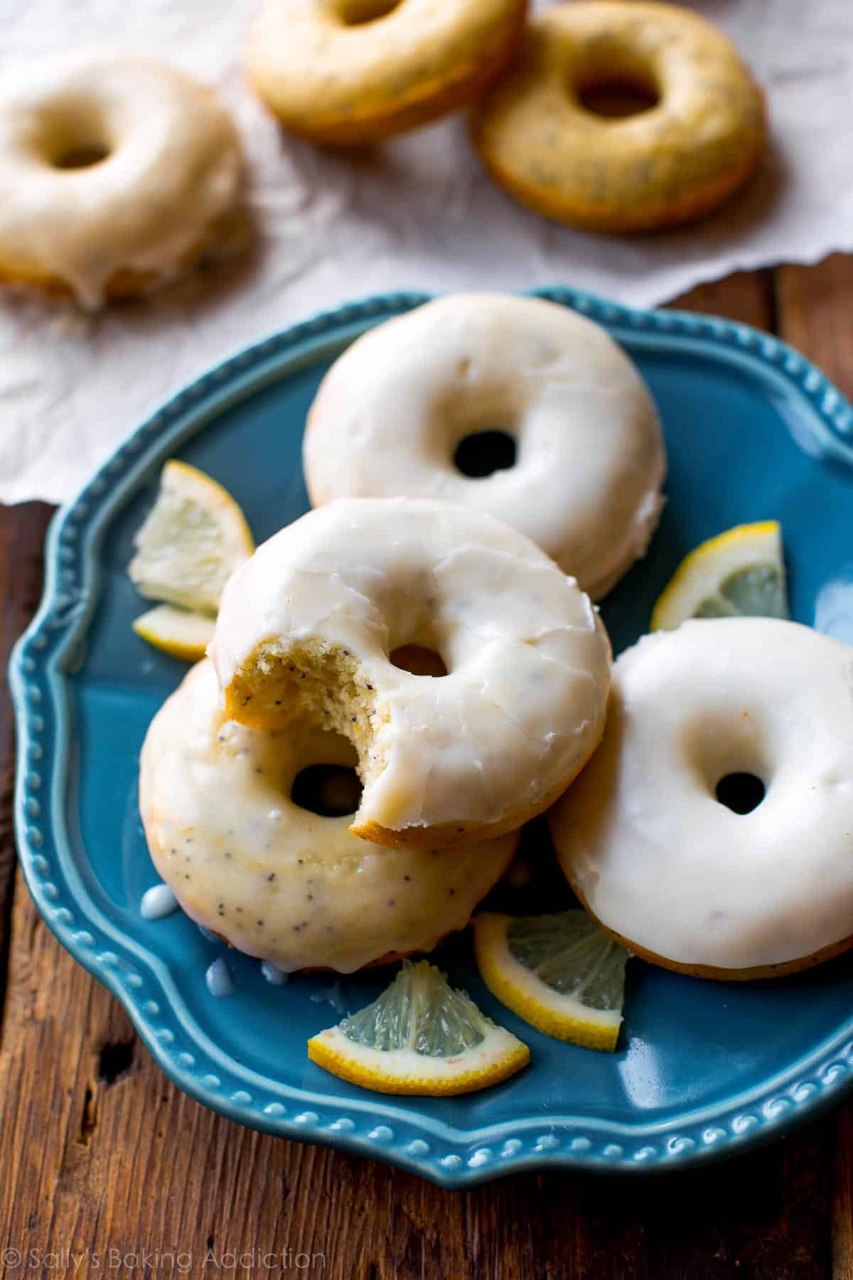 lemon poppy seed donuts on a blue plate