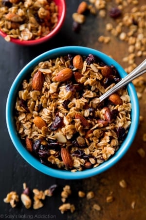 overhead image of maple almond cranberry granola in a blue bowl