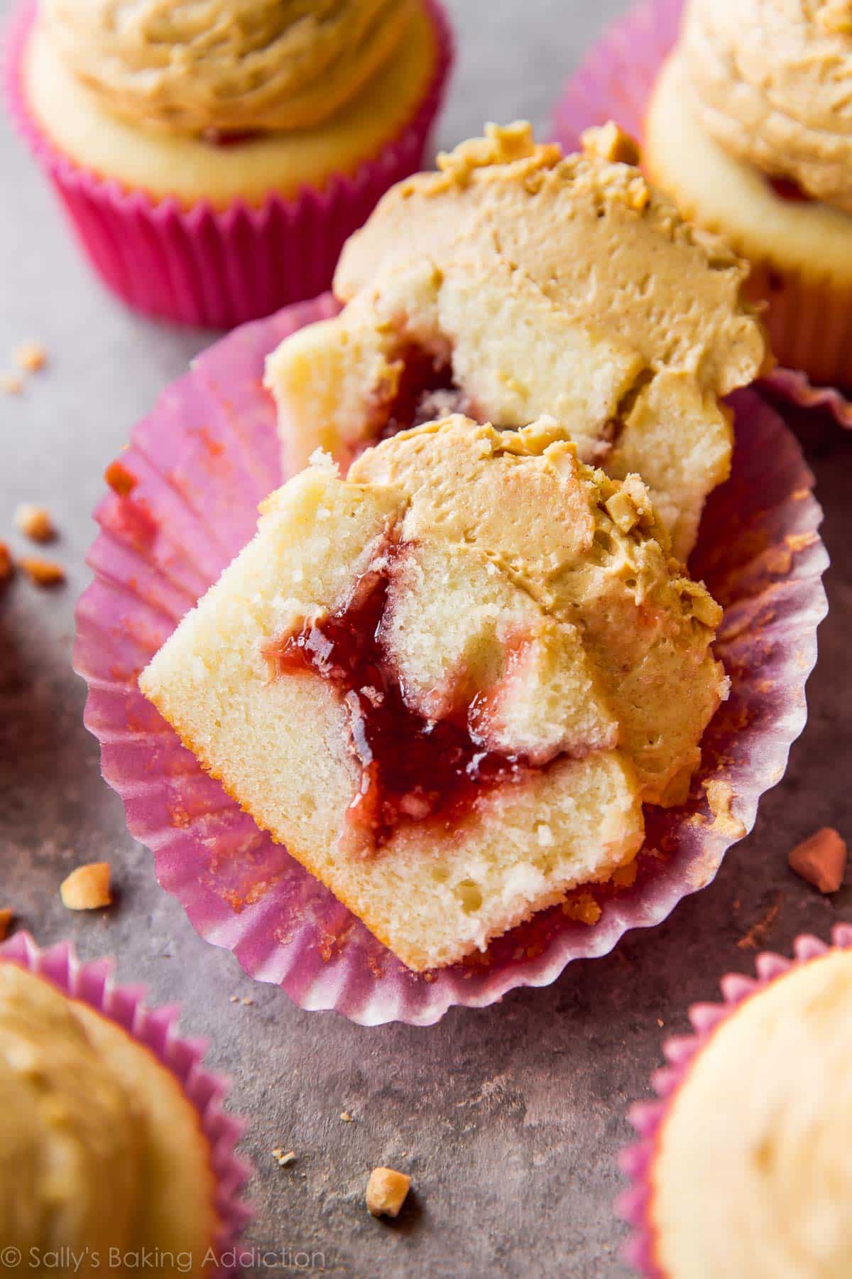 peanut butter and jelly cupcake cut in half showing jam filling
