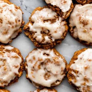 overhead photo of pumpkin oatmeal cookies with icing.