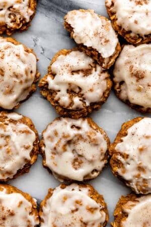 overhead photo of pumpkin oatmeal cookies with icing.