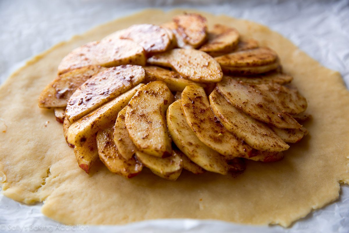 galette dough rolled out with apples on top