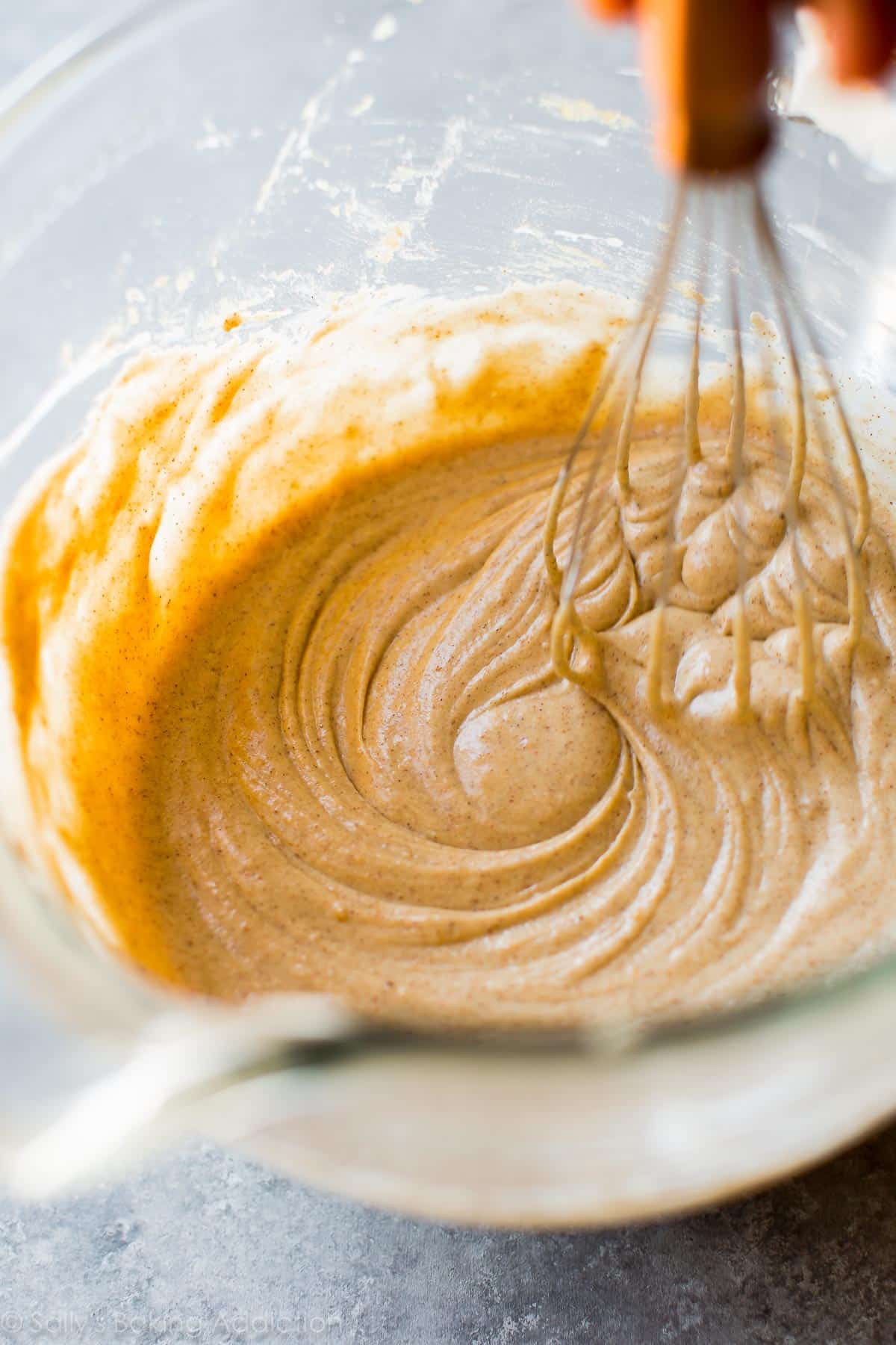 spice cupcake batter in a glass bowl with a whisk