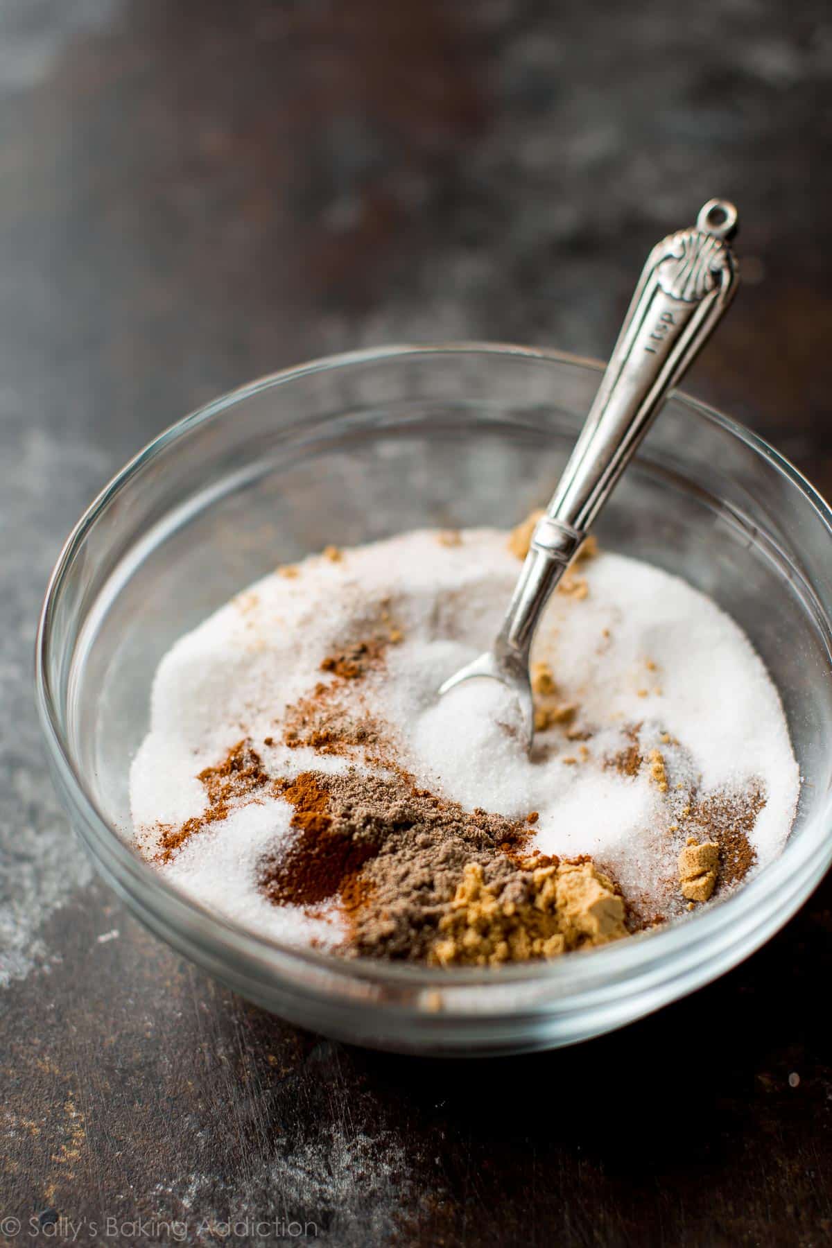 chai spice mixture in a glass bowl with a spoon