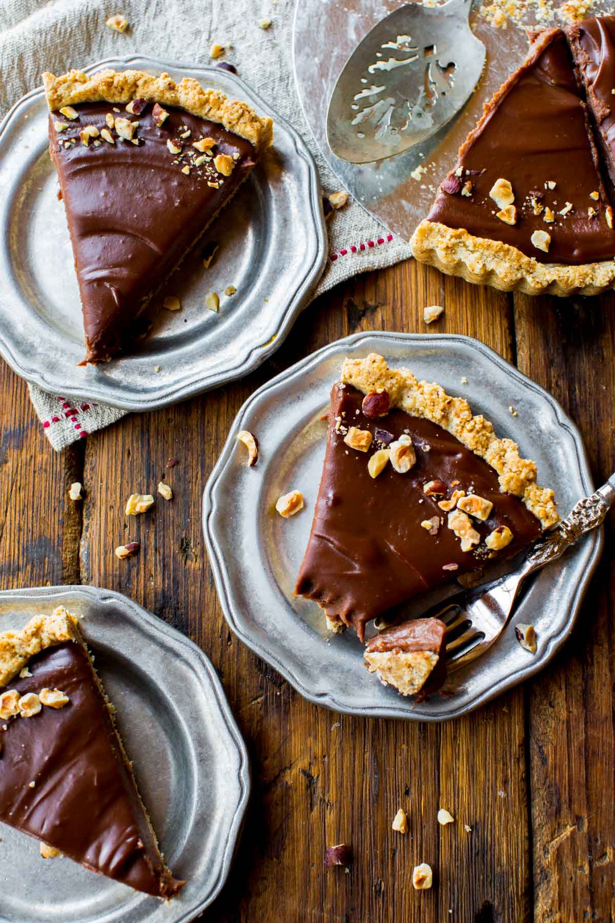 4 slices of Nutella tart on silver plates
