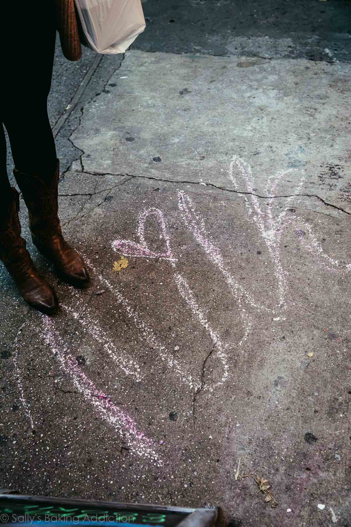 Milk written in chalk on the ground outside of Milk Bar in New York City
