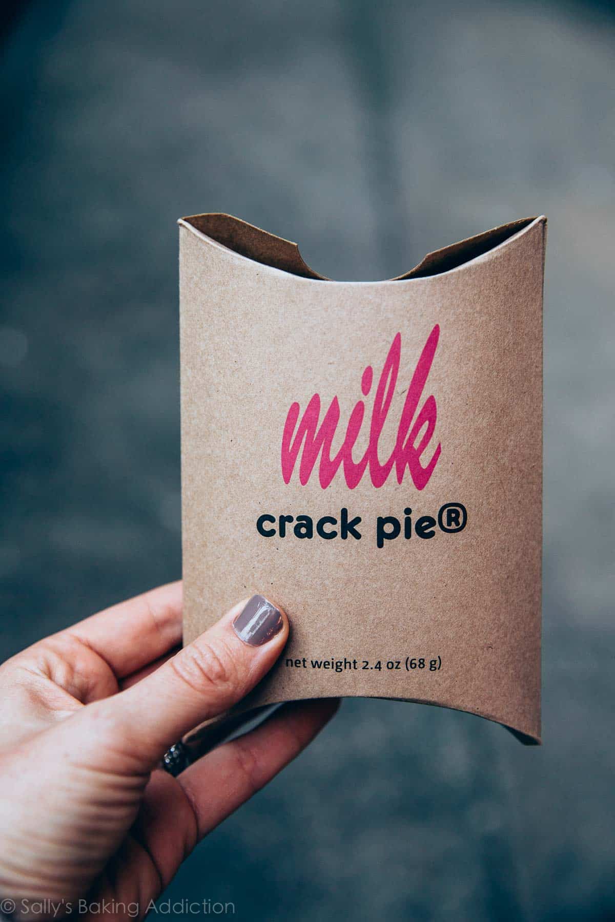 hand holding a container of crack pie from Milk Bar