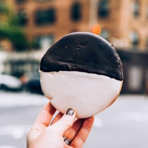 hand holding a black and white cookie