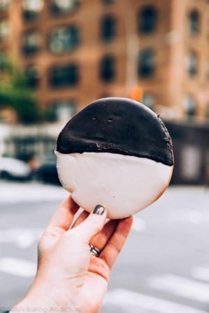 hand holding a black and white cookie