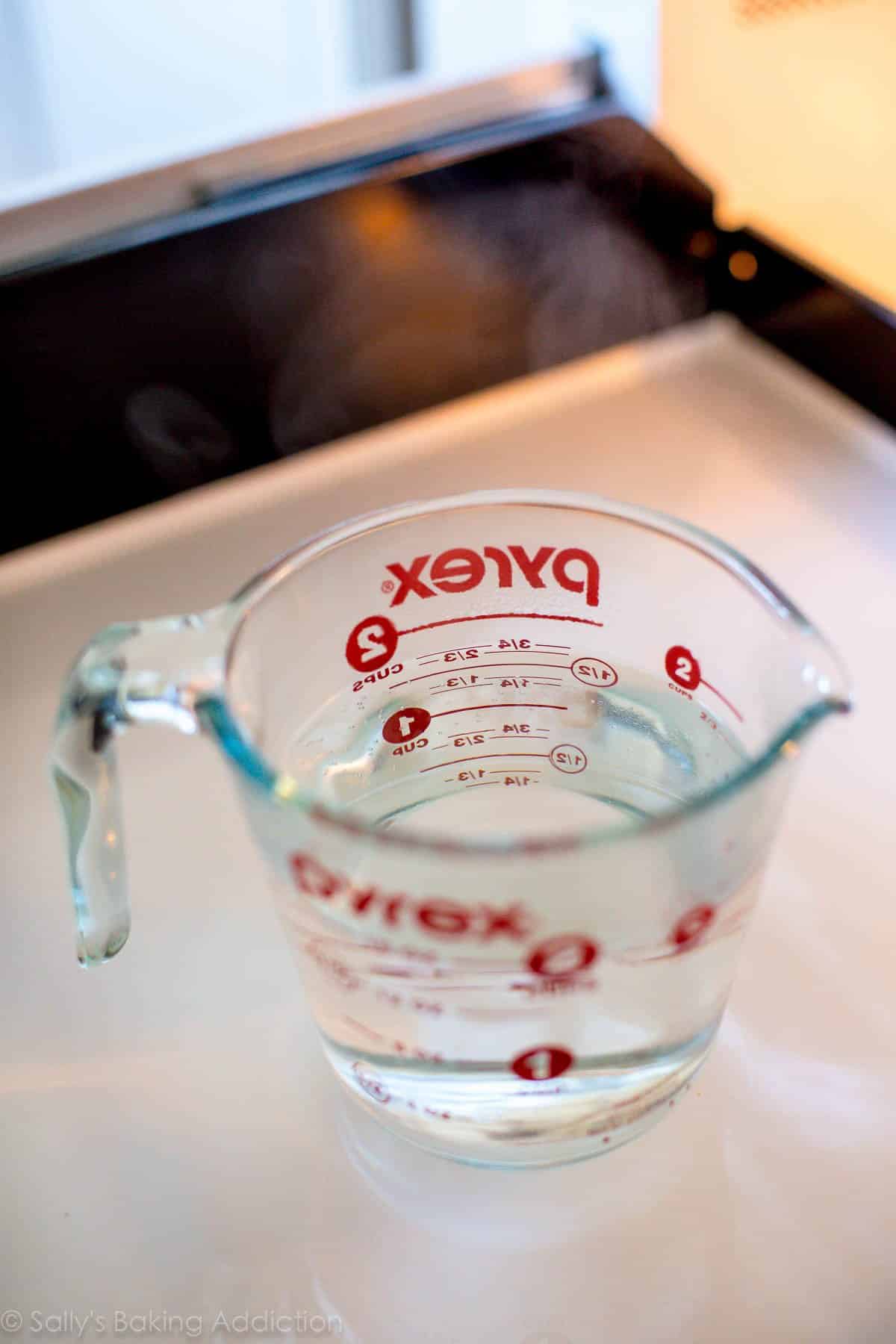 glass liquid measuring cup filled with hot water