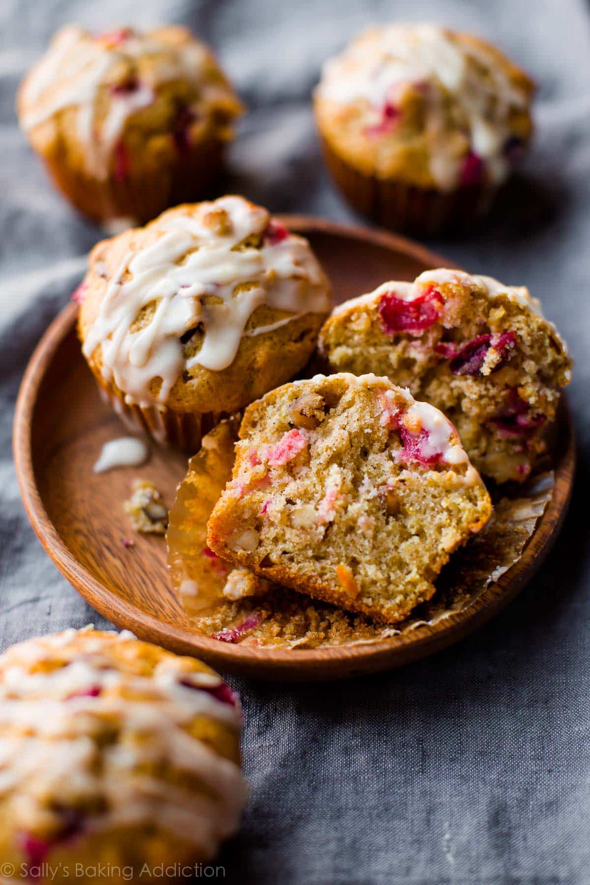 cranberry cardamom spice muffins on a wood plate