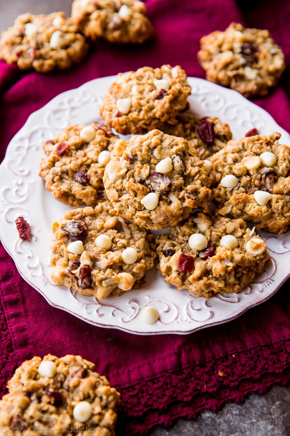 white chocolate cranberry coconut pecan oatmeal cookies on a white plate