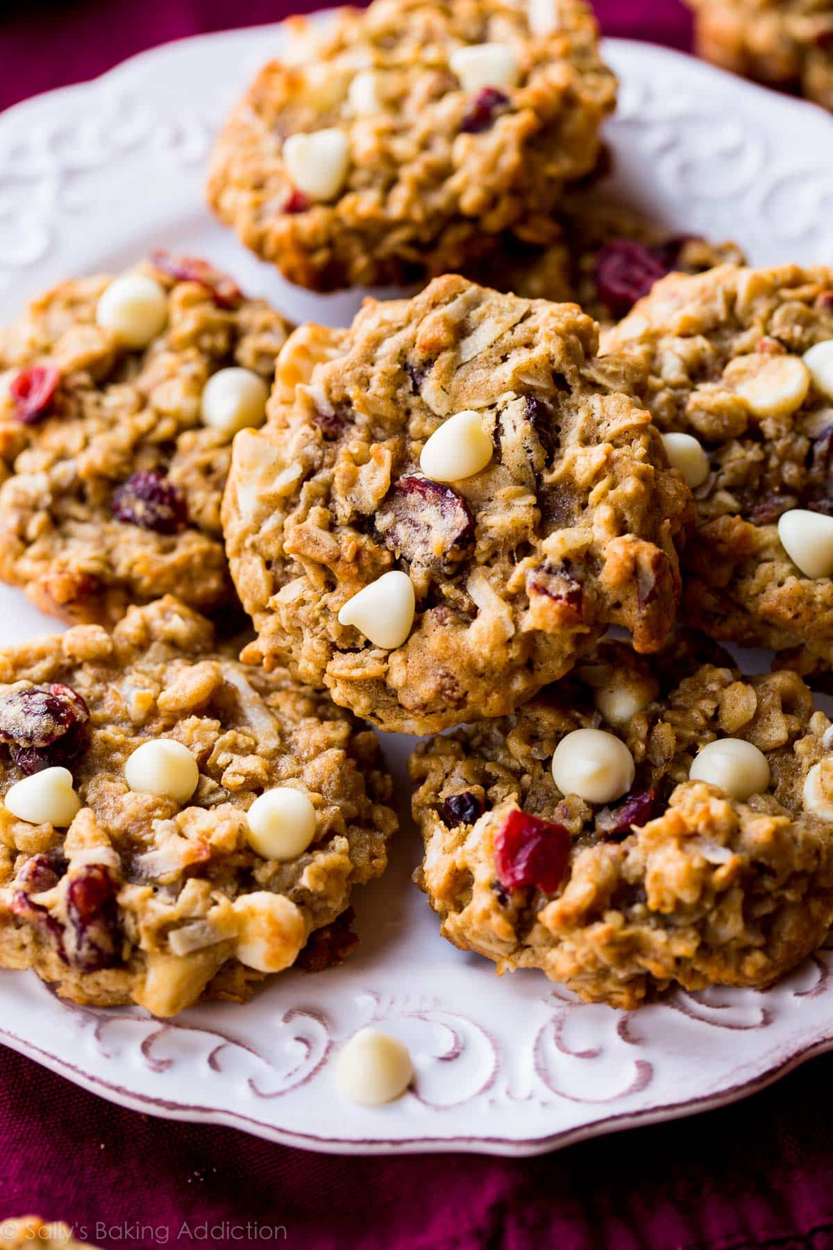 white chocolate cranberry coconut pecan oatmeal cookies on a white plate