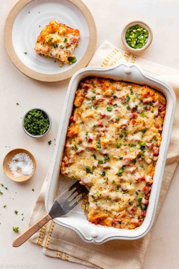 ham, egg, and cheese breakfast strata in white dish.