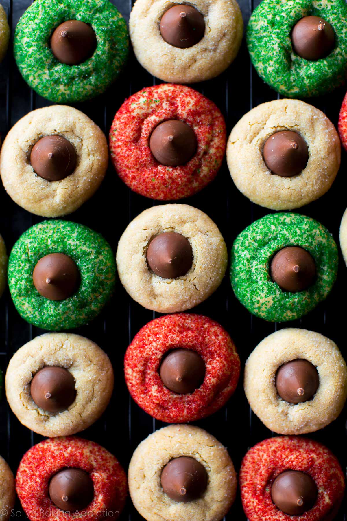 overhead image of peanut butter blossoms with white, green, and red sugar