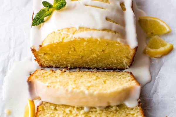 lemon pound cake with lemon glaze with a portion of the cake cut into slices