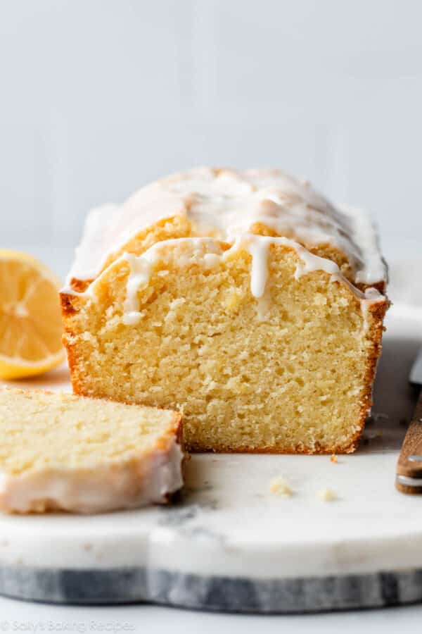 lemon pound cake sliced with icing dripping down in the front.